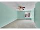 Bright bedroom with a ceiling fan, a large window providing natural light, and plush carpet flooring at 12366 Elm Way, Thornton, CO 80241