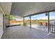 View from covered deck looking out to backyard with wooden fence at 12366 Elm Way, Thornton, CO 80241