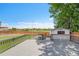 Wooden deck with railings overlooks the fenced backyard and storage shed at 12366 Elm Way, Thornton, CO 80241