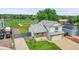 Two-story home with stone accents, attached garage, and lush lawn offering attractive curb appeal and practicality at 12366 Elm Way, Thornton, CO 80241