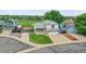 Two-story home featuring neutral siding, stone accents, a well-manicured lawn, and an attached two-car garage at 12366 Elm Way, Thornton, CO 80241