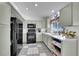 Cozy kitchen featuring black appliances, ample cabinet space, and a checkered tile floor at 12366 Elm Way, Thornton, CO 80241