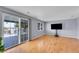 Light-filled living room features hardwood floors, sliding glass doors, and neutral paint at 12366 Elm Way, Thornton, CO 80241