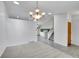 Open concept living space with tile flooring, stairs, and natural lighting at 12366 Elm Way, Thornton, CO 80241