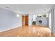Spacious living room featuring hardwood floors, neutral paint, and a sliding glass door to the outside at 12366 Elm Way, Thornton, CO 80241