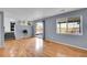 Open living area with hardwood floors, large windows, and sliding glass doors to the outdoors at 12366 Elm Way, Thornton, CO 80241