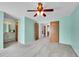 Comfortable main bedroom with ceiling fan, carpet, adjoining bathroom, and a hallway with closet space at 12366 Elm Way, Thornton, CO 80241