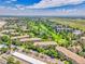 Bird's eye view of a complex located near a golf course, pond, and residential streets under a partly cloudy sky at 3144 S Wheeling Way # 206, Aurora, CO 80014