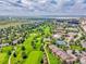Expansive aerial view showcasing the property's location near a golf course, lakes, and cityscapes at 3144 S Wheeling Way # 206, Aurora, CO 80014