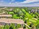 High-angle view of the property nestled within a golf course and overlooking a pond and sand bunkers at 3144 S Wheeling Way # 206, Aurora, CO 80014