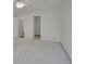 Bright, empty bedroom with a neutral-colored carpet, ceiling fan, and multiple doors to other rooms and closets at 3144 S Wheeling Way # 206, Aurora, CO 80014