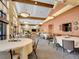Large, open dining area with round tables, chairs, pendant lights, and high ceilings at 3144 S Wheeling Way # 206, Aurora, CO 80014