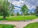 Beautiful golf course view with large deciduous trees, lush green grass and sand traps under a cloudy sky at 3144 S Wheeling Way # 206, Aurora, CO 80014