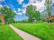 Scenic view of a lush green golf course with mature trees and a walking path under a bright blue sky at 3144 S Wheeling Way # 206, Aurora, CO 80014