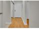 Inviting hallway with mirrored closet and hardwood-style flooring leading to front door at 3144 S Wheeling Way # 206, Aurora, CO 80014