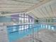 Bright indoor swimming pool featuring lap lanes, large windows, and a high, vaulted ceiling at 3144 S Wheeling Way # 206, Aurora, CO 80014