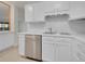 Bright kitchen showcasing stainless steel dishwasher, white cabinetry, white countertop, and neutral flooring, offering ample space at 3144 S Wheeling Way # 206, Aurora, CO 80014