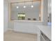 Kitchen area featuring white cabinetry, white countertop, and stainless steel dishwasher with an open view of living space at 3144 S Wheeling Way # 206, Aurora, CO 80014