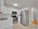 Kitchen featuring white cabinets, stainless steel appliances, white countertop, and neutral flooring, offering ample counter space at 3144 S Wheeling Way # 206, Aurora, CO 80014