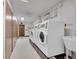 Functional laundry room with multiple washing machines, dryers, and storage, offering convenient laundry facilities at 3144 S Wheeling Way # 206, Aurora, CO 80014