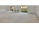 Bright living room with neutral carpet and sliding glass doors to the balcony at 3144 S Wheeling Way # 206, Aurora, CO 80014