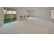 Bright, carpeted living room with balcony access and natural light at 3144 S Wheeling Way # 206, Aurora, CO 80014