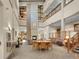 Spacious lobby with fireplace, tables, seating, artwork, and grand staircase at 3144 S Wheeling Way # 206, Aurora, CO 80014