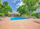 Relaxing outdoor pool area with lounge chairs and a view of the building surrounded by mature trees at 3144 S Wheeling Way # 206, Aurora, CO 80014