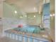 Relaxing hot tub room with tiled walls, overhead lighting, and step-in access for residents at 3144 S Wheeling Way # 206, Aurora, CO 80014
