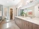 Well-appointed bathroom with a double vanity, glass shower, and walk-in closet at 6096 W Keene Ave, Denver, CO 80235