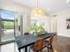 Dining room featuring a modern light fixture, hardwood floors, and sliding glass doors to the outdoor patio at 6096 W Keene Ave, Denver, CO 80235