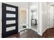 Home entryway with hardwood floors, a modern black door with glass panels, and a view into an office at 6096 W Keene Ave, Denver, CO 80235