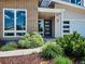 Well-manicured front yard and entrance to home, featuring a modern door at 6096 W Keene Ave, Denver, CO 80235