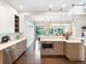 Open-concept kitchen with modern cabinetry, stainless steel appliances, and a view into the dining and living area at 6096 W Keene Ave, Denver, CO 80235