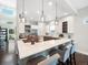 Bright, modern kitchen with a large island, quartz countertop, pendant lighting, and stainless steel appliances at 6096 W Keene Ave, Denver, CO 80235