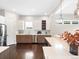 Bright kitchen with quartz countertops, stainless steel appliances, modern cabinets, and hardwood flooring at 6096 W Keene Ave, Denver, CO 80235