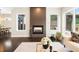 Bright living room showcasing a modern fireplace, dark wood floors, and sleek decor at 6096 W Keene Ave, Denver, CO 80235