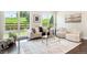 Bright living room with large windows, hardwood floors, neutral-toned furniture, and stylish decor at 6096 W Keene Ave, Denver, CO 80235