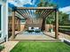 Relax in the outdoor seating area under the beautiful pergola in the private backyard at 6096 W Keene Ave, Denver, CO 80235