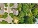 Aerial view of a home with a backyard patio, surrounded by lush greenery and mature trees at 531 Americana Rd, Longmont, CO 80504