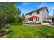 Expansive backyard featuring a well-maintained lawn, patio seating, and beautiful landscaping for outdoor living at 531 Americana Rd, Longmont, CO 80504