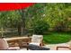 Outdoor patio area with stone seating, surrounded by lush greenery, creating a serene backyard retreat at 531 Americana Rd, Longmont, CO 80504