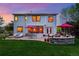 Spacious backyard with a stone patio, lounge chairs, dining area, and lush lawn for outdoor enjoyment at 531 Americana Rd, Longmont, CO 80504