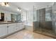 Bright bathroom features a glass shower, soaking tub, and dual sink vanity at 531 Americana Rd, Longmont, CO 80504