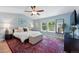 Bright primary bedroom with a ceiling fan, an area rug, and large windows that let in tons of natural light at 531 Americana Rd, Longmont, CO 80504