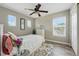 Cozy bedroom featuring a ceiling fan, three windows for natural light, and neutral paint at 531 Americana Rd, Longmont, CO 80504