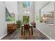 Bright dining room features high ceilings, modern chandelier, and stylish decor providing an elegant space for gatherings at 531 Americana Rd, Longmont, CO 80504