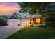 Charming two-story home with a three-car garage, lovely landscaping, and a cozy front porch with stone accents at 531 Americana Rd, Longmont, CO 80504