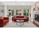 Bright and airy living room with large windows, stylish furnishings, and a cozy fireplace, creating an inviting atmosphere at 531 Americana Rd, Longmont, CO 80504