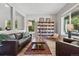 Spacious living room with large bookshelf, stylish furniture, wood floors, and natural light, perfect for relaxing at 531 Americana Rd, Longmont, CO 80504